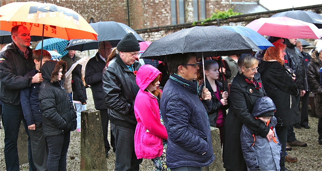 Hundreds pay tribute at rain-swept memorials